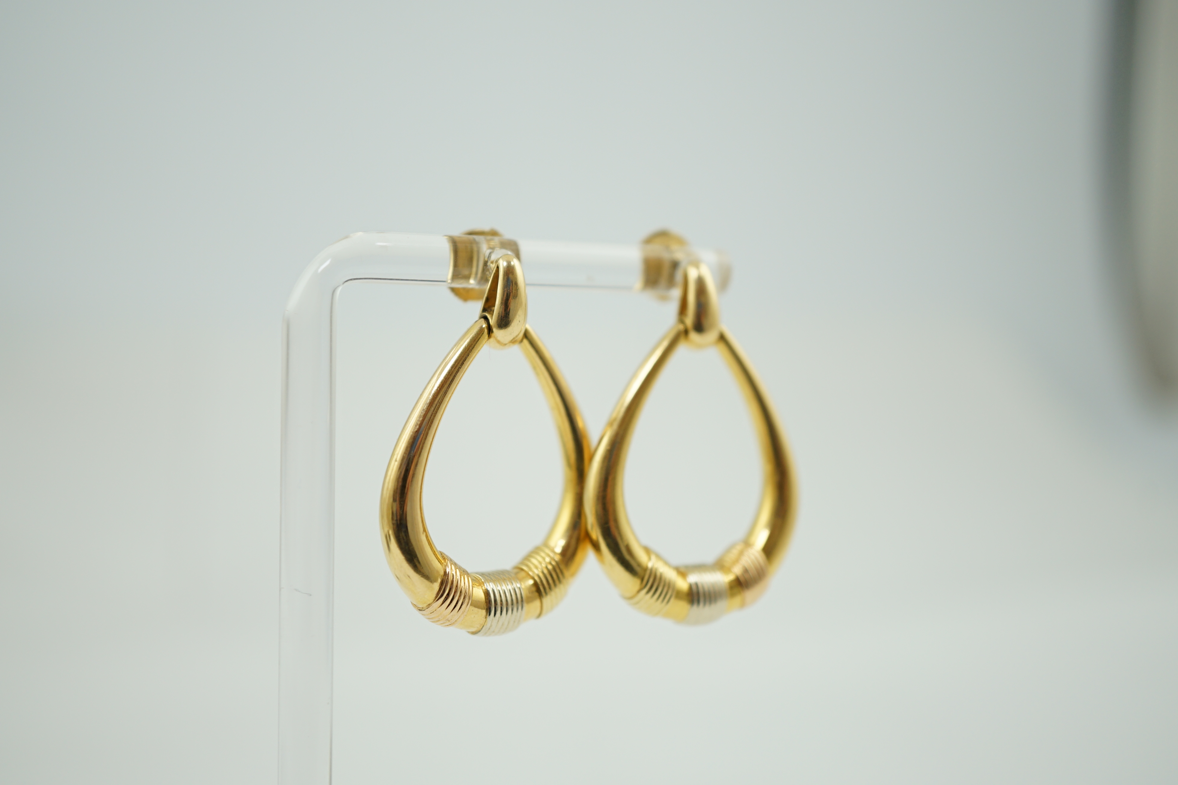 A modern pair of Cartier three colour 18k gold loop earrings